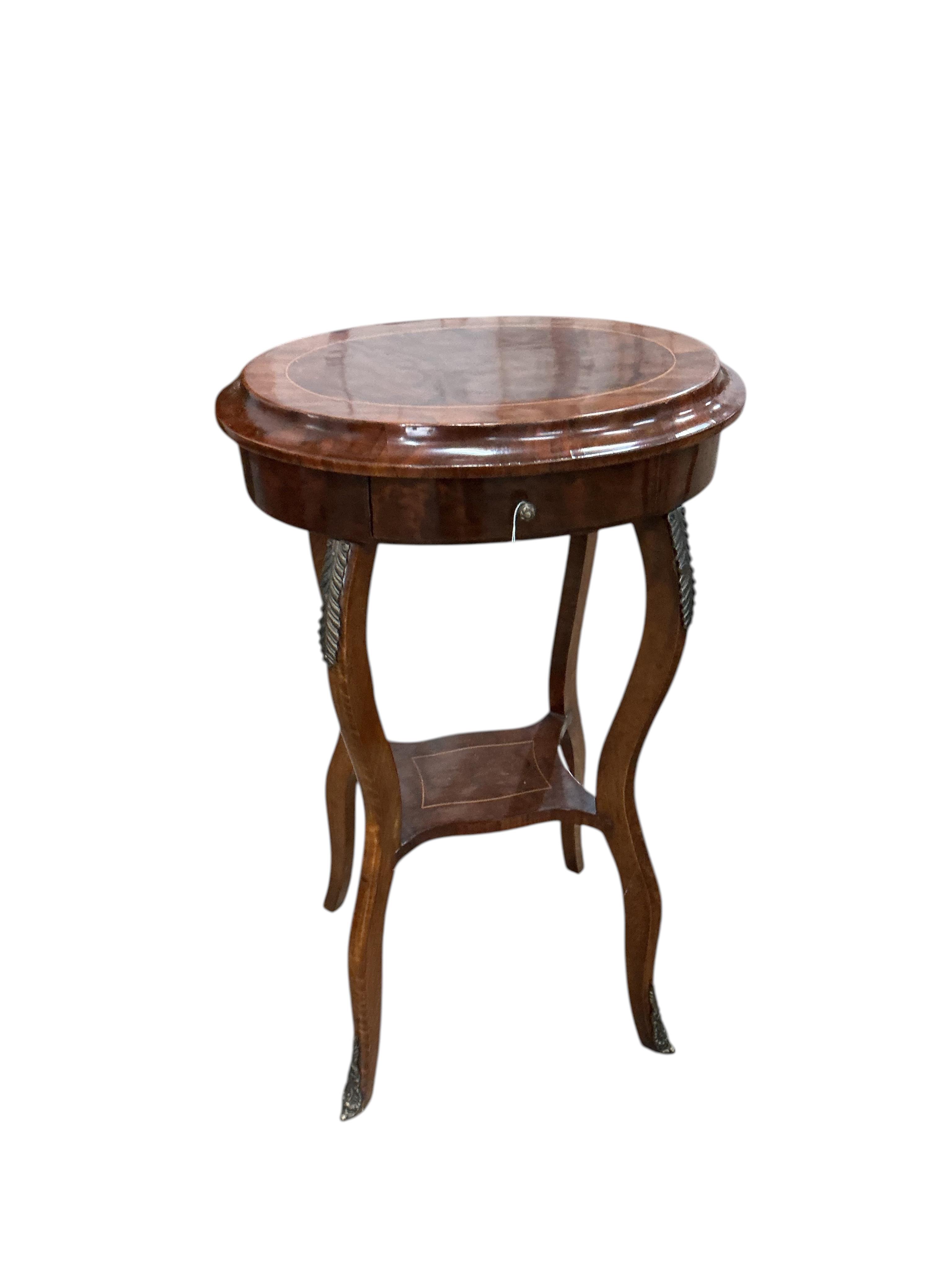 A pair of Louis XVI style oval gilt metal mounted walnut two tier occasional tables, width 45cm, depth 33cm, height 76cm